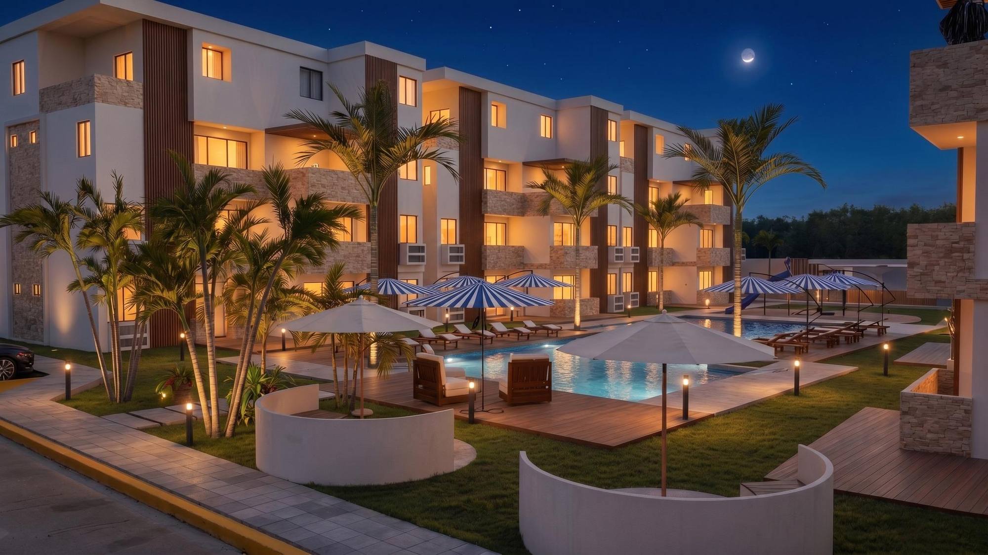 Render nocturno de Latitud Village con la piscina iluminada